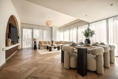 a living room with a table and chairs at Seraya Residence 20 - 4BDR - Burj View with direct access to Dubai Mall in Dubai