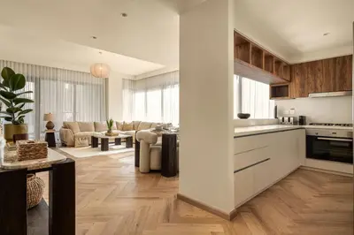 a kitchen and living room with wooden floors and a living room at Seraya Residence 20 - 4BDR - Burj View with direct access to Dubai Mall in Dubai