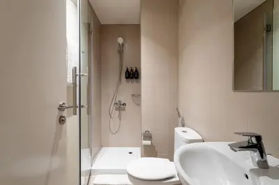 a bathroom with a shower and a sink and a toilet at Seraya Residence 20 - 4BDR - Burj View with direct access to Dubai Mall in Dubai