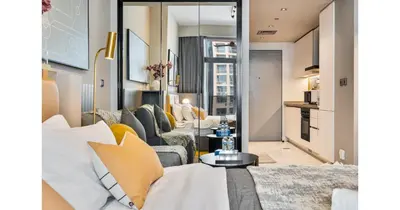 a living room with a couch and a table at Stylish Studio - 5-min walk Burj Khalifa & Dubai Mall in Dubai