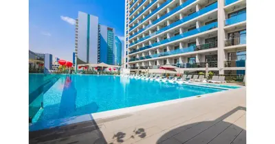 a large swimming pool in front of a building at Stylish Studio - 5-min walk Burj Khalifa & Dubai Mall in Dubai