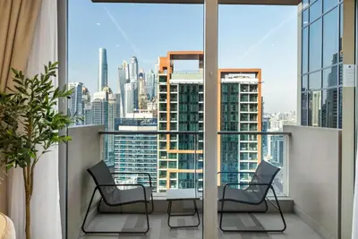 a balcony with chairs and a view of a city at Luxury Studio Near Beach and Sea in Dubai Marina in Dubai