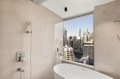 a bathroom with a toilet and a view of a city at Luxury Studio Near Beach and Sea in Dubai Marina in Dubai