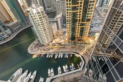 an aerial view of a city with boats in a harbor at Luxury Studio Near Beach and Sea in Dubai Marina in Dubai