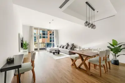 a white living room with a table and chairs at Dubai 1BR City Views, Near Downtown Dining, Culture & Attractions in Dubai