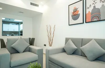 a living room with two couches and a window at Zapbed House-Stylish 2 BR in May Residence Block 1 -JVC in Dubai