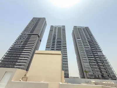 two tall buildings standing next to each other at Zapbed House-Stylish 2 BR in May Residence Block 1 -JVC in Dubai