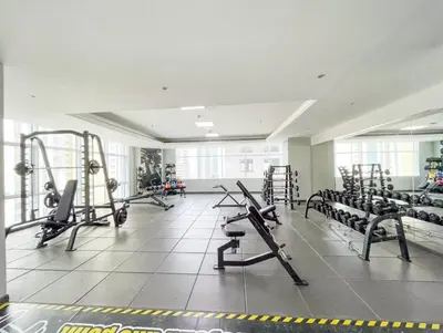 a gym with rows of treadmills and machines at 2BR Dubai City Skyline View Near Marina Walk Dining Shops & JBR in Dubai