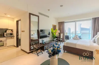 a hotel room with a bed and a large mirror at The Cozy in Dubai