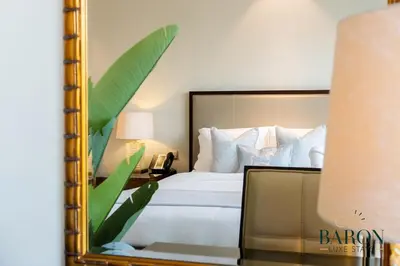 a bedroom with a large bed and a mirror at The Cozy in Dubai