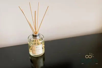 a bottle of whiskey with sticks in it at The Cozy in Dubai