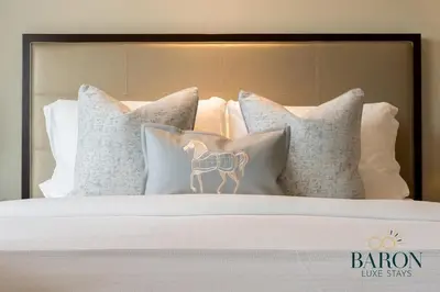 a bed with pillows with a horse on it at The Cozy in Dubai