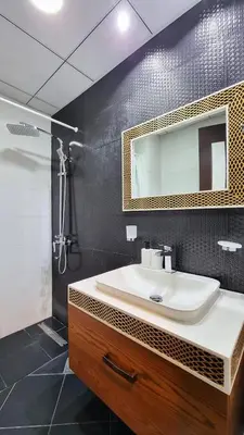 a bathroom with a sink and a shower and a mirror at Business Bay, Compact, Modern Studio Dubai in Dubai