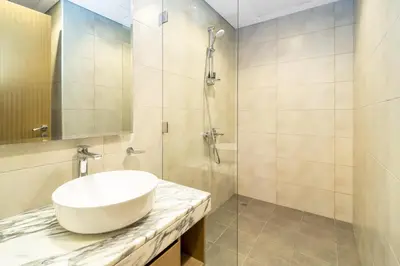 a bathroom with a sink and a shower at Cozy 2BR Pool & City Views in Dubai