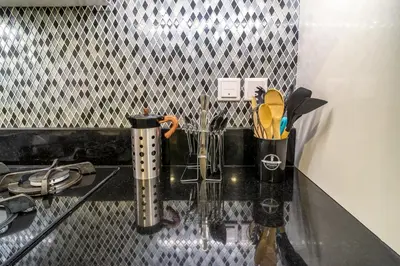 a counter with two cups and utensils on it at Cozy 2BR Pool & City Views in Dubai
