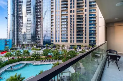 a view of the pool from the balcony of a hotel at Cozy 2BR Pool & City Views in Dubai