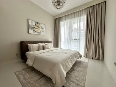 a bedroom with a large bed and a large window at Modern & Cozy 1BR with Great Amenities, Grand Bleu in Dubai