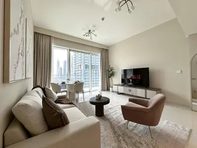 a living room with a couch and a tv at Modern & Cozy 1BR with Great Amenities, Grand Bleu in Dubai