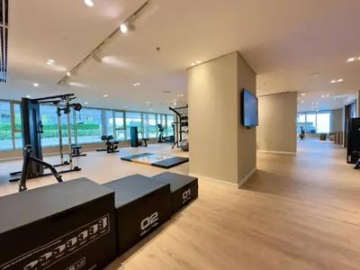 a gym with treadmills and a flat screen tv at Modern & Cozy 1BR with Great Amenities, Grand Bleu in Dubai