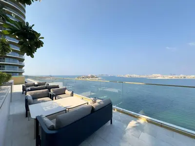 a balcony with couches and a view of the water at Modern & Cozy 1BR with Great Amenities, Grand Bleu in Dubai