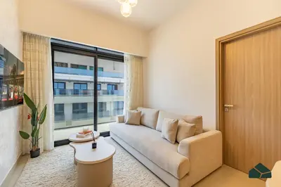 a living room with a couch and a large window at Peaceful 2BR with Community Views by BMS in Dubai