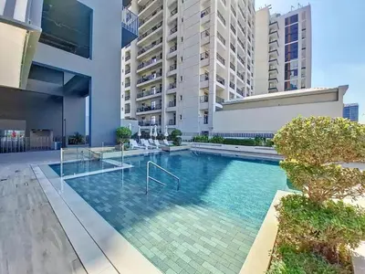 a swimming pool in the middle of a building at HAVN - 1 Spacious Bedroom in Belgravia 1, JVC in Dubai