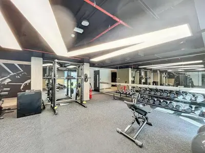 a gym with a lot of equipment in a room at HAVN - 1 Spacious Bedroom in Belgravia 1, JVC in Dubai