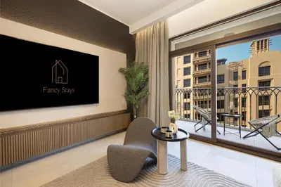 a living room with a large window and a tv at Luxury apartment with Iconic Landmark View, pool, gym, free parking in Dubai