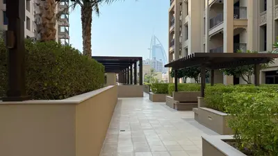 a walkway in a city with buildings and trees at Luxury apartment with Iconic Landmark View, pool, gym, free parking in Dubai