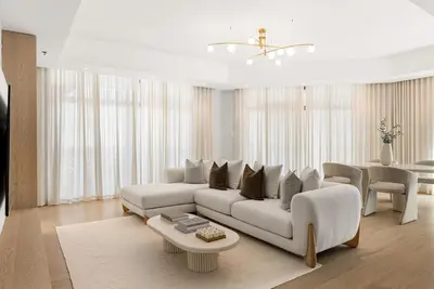 a living room with a white couch and a table at DAYF-ROD Luxurious 2 Bed Apartment in Souk Al Bahar in Dubai