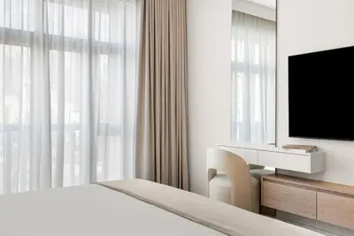 a hotel room with a bed and a television at DAYF-ROD Luxurious 2 Bed Apartment in Souk Al Bahar in Dubai