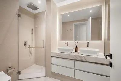 a bathroom with two sinks and a shower at DAYF-ROD Luxurious 2 Bed Apartment in Souk Al Bahar in Dubai