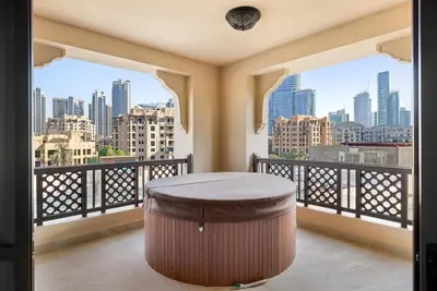 a room with a large ottoman on a balcony at DAYF-ROD Luxurious 2 Bed Apartment in Souk Al Bahar in Dubai