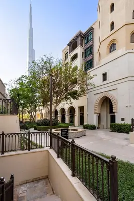 a staircase leading to a building with a tower in the background at DAYF-ROD Luxurious 2 Bed Apartment in Souk Al Bahar in Dubai