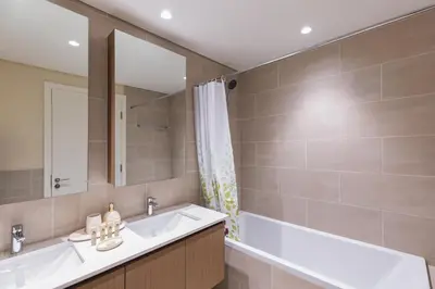 a bathroom with a sink and a mirror at Maison Privee - Creekside Elegance with Canal Vws at Creek Beach in Dubai