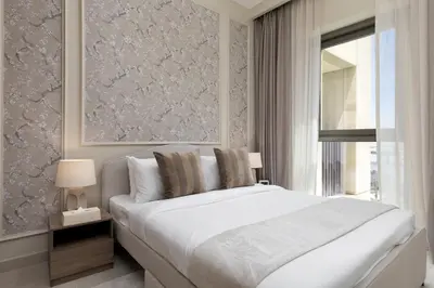 a bedroom with a large white bed and a window at Maison Privee - Creekside Elegance with Canal Vws at Creek Beach in Dubai