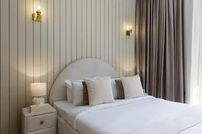 a bedroom with a white bed with white pillows at Maison Privee - Creekside Elegance with Canal Vws at Creek Beach in Dubai