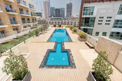 an overhead view of a swimming pool on an apartment building at Urban Comfort 1Bedroom with Pool View in Oxford in Dubai