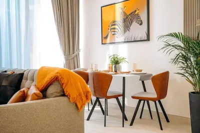 a living room with a table and a zebra picture on the wall at Amazing brand new 2BR - Business Bay-Binghatti in Dubai