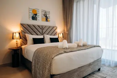 a bedroom with a large bed and a window at Amazing brand new 2BR - Business Bay-Binghatti in Dubai