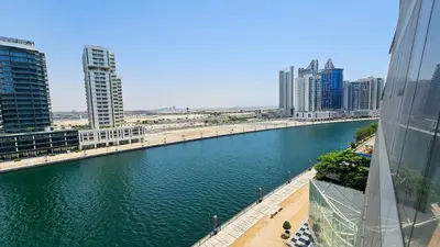 a river in the middle of a city with tall buildings at Luxurious Lake View 1BR - Business Bay - Pool - Gym in Dubai