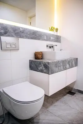 a bathroom with a white toilet and a sink at Luxurious Lake View 1BR - Business Bay - Pool - Gym in Dubai