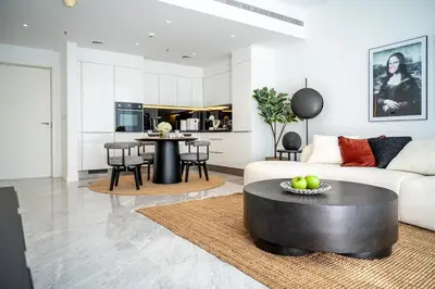 a living room with a couch and a table at Luxurious Lake View 1BR - Business Bay - Pool - Gym in Dubai