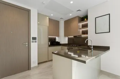 a kitchen with a sink and a counter top at Bright 1 Bedroom with Burj Khalifa view in Peninsula in Dubai