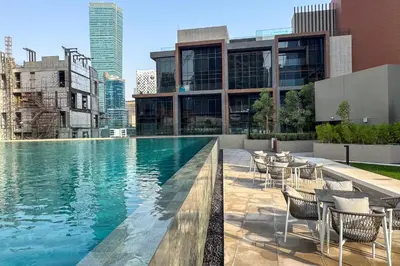 a swimming pool on the roof of a building at Bright 1 Bedroom with Burj Khalifa view in Peninsula in Dubai
