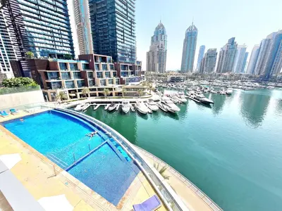 a view of a river with boats in a city at Luxury 2BR in Cayan Tower with Stunning Views in Dubai