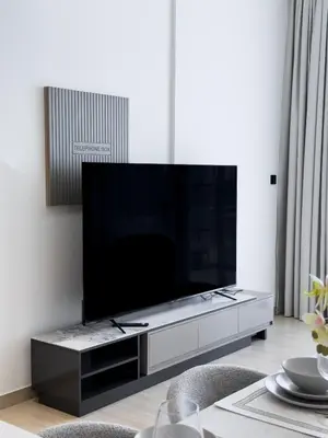 a living room with a large flat screen tv at Stunning 1BR in Binghatti Corner, JVC in Dubai