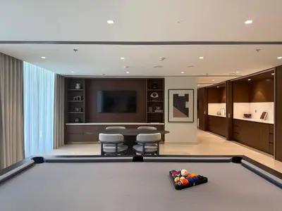 a living room with a pool table and a tv at Luxury & Bright 1BR Apartment | Panoramic Sea View in Dubai