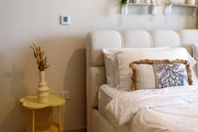 a bedroom with a bed and a vase on a table at Tropical Nest in Dubai