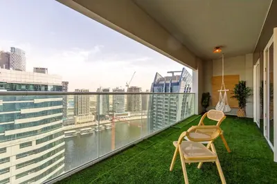 a balcony with two chairs and a view of the city at Tropical Nest in Dubai